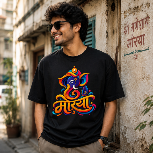 A man wearing a black t-shirt with a colorful, vibrant Ganesha graphic print, Ganapati Utsav